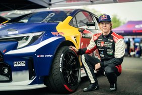 Kalle Rovanperä posing with a hand on an ADVAN NEOVA AD09 tyre