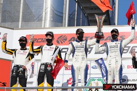 On the podium (from left), Kakunoshin Ohta & Takashi Kobayashi (2nd place) and winners Joao Paulo de Oliveira & Kiyoto Fujinami